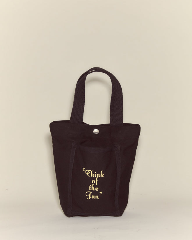 The Small Geneva Tote is a black cotton canvas bag from Camp Geneva, featuring "Think of the Fun" in yellow text on its front pocket.